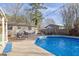 Backyard with a sparkling pool, outdoor seating, and a lounge chair, perfect for summer relaxation at 4570 Nantucket Sw Dr, Lilburn, GA 30047