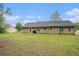 Expansive backyard with lush lawn, perfect for outdoor activities, and exterior view of the home at 60 Cypress Dr, Covington, GA 30016