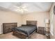 Bedroom with rustic furniture set, neutral walls, and ceiling fan with light fixture at 60 Cypress Dr, Covington, GA 30016