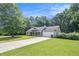 Traditional-style home with a long driveway, spacious front yard, and an attached garage at 60 Cypress Dr, Covington, GA 30016