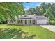 Charming single-story home featuring a well-manicured lawn, inviting front porch, and attached two-car garage at 60 Cypress Dr, Covington, GA 30016