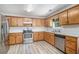 Cozy kitchen with stainless steel appliances, light countertops, and sleek flooring at 60 Cypress Dr, Covington, GA 30016
