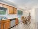 Eat-in kitchen with stainless steel dishwasher and wood cabinets offers ample space for cooking and dining at 60 Cypress Dr, Covington, GA 30016