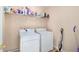 Laundry room featuring a washer, dryer, and shelving at 60 Cypress Dr, Covington, GA 30016
