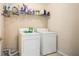 Laundry room featuring a washer, dryer, and overhead storage shelf at 60 Cypress Dr, Covington, GA 30016
