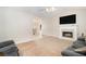 Bright living room features a cozy fireplace, plush carpeting, and ample natural light at 60 Cypress Dr, Covington, GA 30016