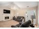 Cozy living room with a fireplace, ceiling fan, and comfortable seating at 60 Cypress Dr, Covington, GA 30016