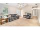 Cozy living room featuring neutral walls, comfortable seating, and natural light from a front-facing window at 60 Cypress Dr, Covington, GA 30016