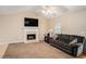 Living room featuring a fireplace with a TV and a comfortable sofa at 60 Cypress Dr, Covington, GA 30016