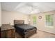 Comfortable main bedroom with natural light and ceiling fan at 60 Cypress Dr, Covington, GA 30016