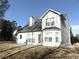 Exterior backyard view of the home and stone patio at 1662 Maple Trace Ct, Grayson, GA 30017