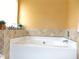Bathroom featuring a large white soaking tub at 1662 Maple Trace Ct, Grayson, GA 30017