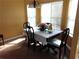 Charming dining area with a table set for four, complemented by ample natural light from the surrounding windows at 1662 Maple Trace Ct, Grayson, GA 30017