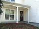 Exterior of the front entrance with dark stained wood door and white trim at 1662 Maple Trace Ct, Grayson, GA 30017
