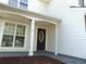Exterior of the front entrance with dark stained wood door and white trim at 1662 Maple Trace Ct, Grayson, GA 30017