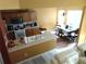 Bright kitchen with wood cabinets, a breakfast bar, and an adjacent dining area filled with natural light at 1662 Maple Trace Ct, Grayson, GA 30017