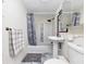 Bathroom with a shower and tub combination, pedestal sink, and gray patterned flooring at 2285 Peachtree Rd Ne # 803, Atlanta, GA 30309