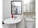 Bright bathroom with a pedestal sink, mirror, and ample storage space and toilet at 2285 Peachtree Rd Ne # 803, Atlanta, GA 30309