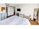 Bedroom with hardwood floors, a comfortable bed with a grey blanket and a decorative mirror at 2285 Peachtree Rd Ne # 803, Atlanta, GA 30309