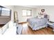 Cozy bedroom with hardwood floors and a comfortable bed with a grey blanket and decorative pillows at 2285 Peachtree Rd Ne # 803, Atlanta, GA 30309