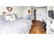 Bedroom with hardwood floors, a comfortable bed with a grey blanket and a connected desk at 2285 Peachtree Rd Ne # 803, Atlanta, GA 30309