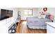 Bright bedroom with hardwood floors, large window, and comfortable bed with decorative pillows at 2285 Peachtree Rd Ne # 803, Atlanta, GA 30309