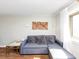 A corner sectional sofa sits below a window letting in natural light at 2285 Peachtree Rd Ne # 803, Atlanta, GA 30309