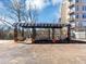Outdoor lounge featuring seating, tables, and a trellis-covered area with garden views at 2285 Peachtree Rd Ne # 803, Atlanta, GA 30309