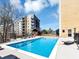Community swimming pool with lounge chairs and building views at 2285 Peachtree Rd Ne # 803, Atlanta, GA 30309