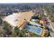 An aerial view showcasing the community's lake, tennis courts and pool at 2664 Stonebrook Ne Ct, Roswell, GA 30075