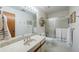 Well-lit bathroom featuring tile flooring, and a shower-tub combo with a large vanity mirror at 2664 Stonebrook Ne Ct, Roswell, GA 30075