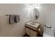 Cozy bathroom with a single sink vanity, toilet, and a decorative mirror at 2664 Stonebrook Ne Ct, Roswell, GA 30075