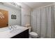 Bathroom with black and white striped shower curtain and a modern vanity at 2664 Stonebrook Ne Ct, Roswell, GA 30075