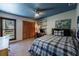 Comfortable bedroom features unique lighting and a large window for natural light at 2664 Stonebrook Ne Ct, Roswell, GA 30075