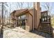 Exterior view of home with wood siding and a deck overlooking the backyard at 2664 Stonebrook Ne Ct, Roswell, GA 30075