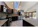 Modern kitchen boasts stainless appliances, granite countertops, dark wood cabinets, and tiled backsplash at 2664 Stonebrook Ne Ct, Roswell, GA 30075