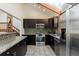 Well-lit modern kitchen features stainless appliances, granite countertops, and tiled floors at 2664 Stonebrook Ne Ct, Roswell, GA 30075