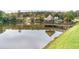 Scenic view of a gazebo on a lake with surrounding greenery and neighborhood homes at 2664 Stonebrook Ne Ct, Roswell, GA 30075