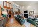 Open living room boasts soaring ceilings, hardwood floors, a fireplace, and 2nd-floor landing at 2664 Stonebrook Ne Ct, Roswell, GA 30075