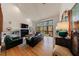 Bright living room with a fireplace, hardwood floors, high ceilings, and a wall of windows at 2664 Stonebrook Ne Ct, Roswell, GA 30075
