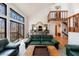 Bright living room boasts large windows with wooded views, filling the space with natural light at 2664 Stonebrook Ne Ct, Roswell, GA 30075