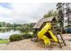 Fun playground area with slides, swings, and a view of the lake at 2664 Stonebrook Ne Ct, Roswell, GA 30075