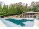 A covered pool with a stone pool house overlooking the water at 2664 Stonebrook Ne Ct, Roswell, GA 30075