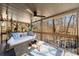 Outdoor covered porch with cushioned swing and a view of the wooded landscape at 2664 Stonebrook Ne Ct, Roswell, GA 30075