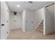 Unfinished basement area with carpet flooring and access to stairs and utility doors at 6710 Hidden Brook Trl, Atlanta, GA 30349