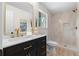 Bathroom featuring a modern vanity with gold hardware and a walk-in shower with textured tile at 6710 Hidden Brook Trl, Atlanta, GA 30349