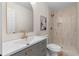 Bathroom featuring modern vanity with gold hardware and walk-in shower with decorative tile at 6710 Hidden Brook Trl, Atlanta, GA 30349