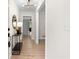 Bright entryway featuring wood floors, modern lighting fixture, and stylish console table at 6710 Hidden Brook Trl, Atlanta, GA 30349