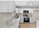 Contemporary kitchen featuring white cabinets, stainless steel appliances, and quartz countertops at 6710 Hidden Brook Trl, Atlanta, GA 30349