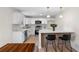 Bright kitchen featuring white cabinets, stainless steel appliances, and an island with bar stool seating at 6710 Hidden Brook Trl, Atlanta, GA 30349